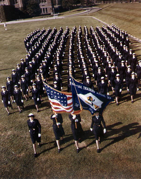 Trainees of US Naval Training Center, Hunter College, Bronx, New York, United States marching in formation behind their color guard, during WW2