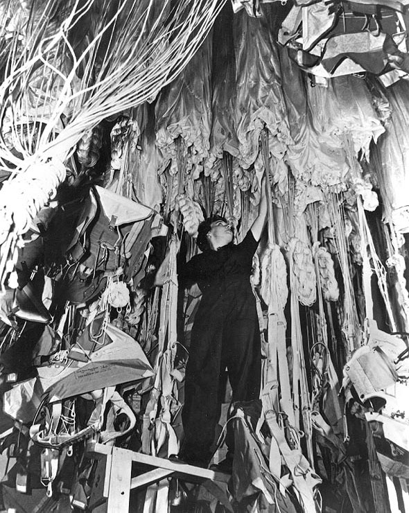 WAVES Parachute Rigger working in a Naval Air Station's parachute loft, date unknown