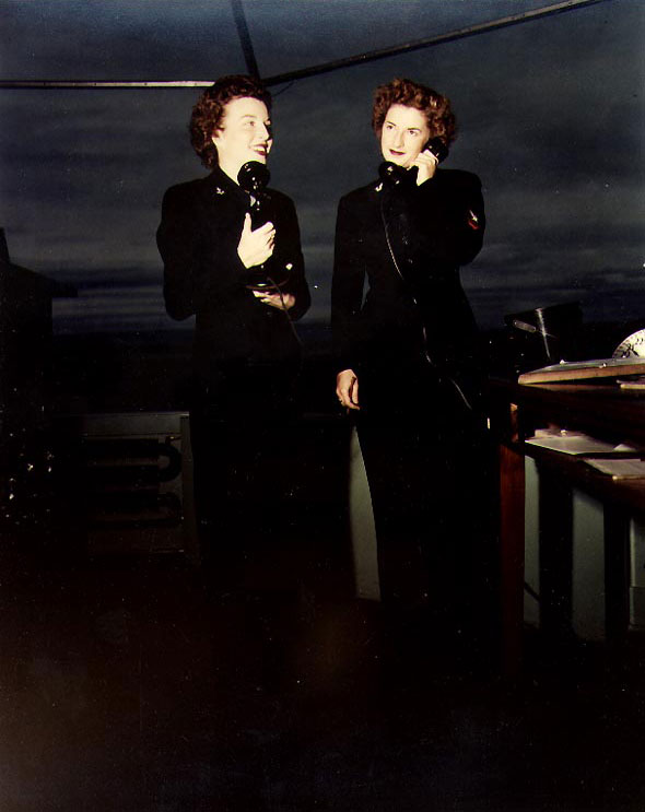WAVES Specialist (Y) 2nd Class Janna Hoffman and Specialist (Y) Helen Lu Dooley handling control tower duties at Naval Air Station, Moffett Field, California, United States, circa 1944-1945