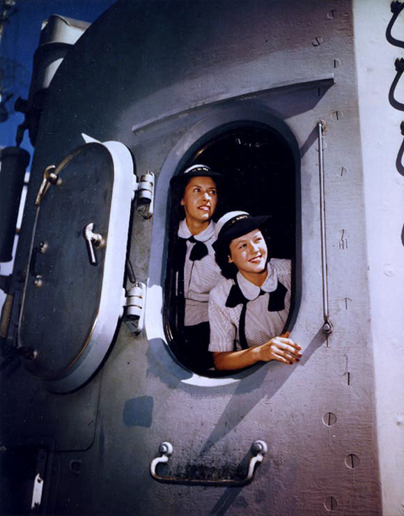 WAVES Yeoman Second Class Blanche Oswald and Yeoman Third Class Betty Martin in a 5in twin gun turret aboard Missouri, Norfolk Navy Yard, Virginia, United States, 19 Aug 1944