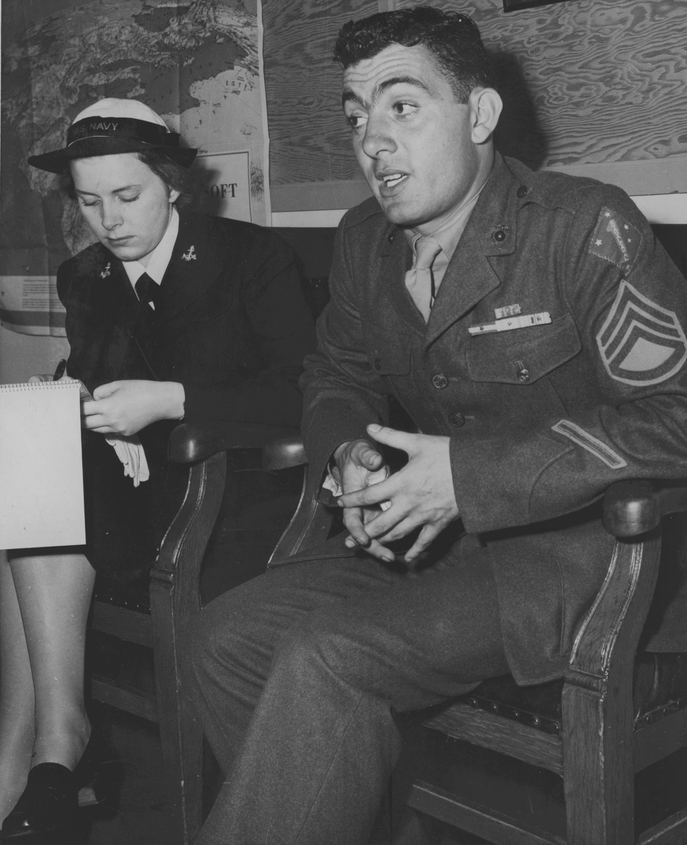 Platoon Sergeant John Basilone being interviewed by US Navy WAVE Yeoman 3rd Class Sigrid Shield, Sep 1943