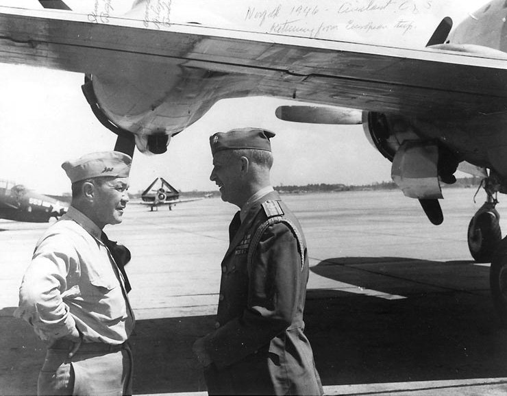 RAdm Gerald Bogan and Commodore A. Burke, Naval Air Station Norfolk, Virginia, United States, summer 1946; note wing of R5D Skymaster aircraft and TBF Avenger, SNJ, and SB2C Helldiver in background