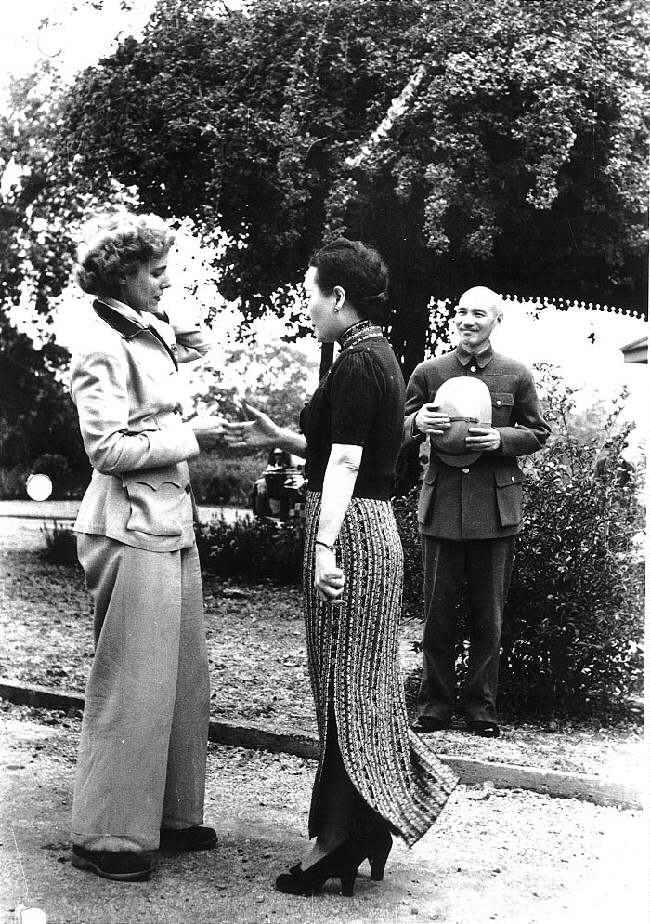 Song Meiling welcoming journalist Clare Boothe Luce, Maymyo, Burma, 19 Apr 1942; Chiang Kaishek in background