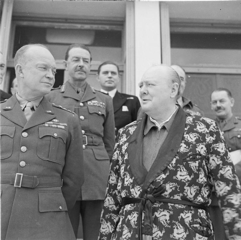 Dwight Eisenhower and Winston Churchill in Tunisia, 25 Dec 1943, photo 2 of 2; Churchill was in a robe in this photo because he was recovering from pneumonia