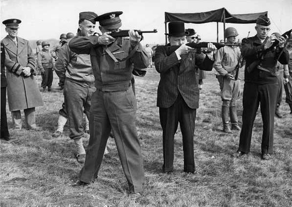 Major General Edward Brooks (behind Eisenhower) demonstrating M1 Carbines to Dwight Eisenhower, Winston Churchill, and Omar Bradley, England, United Kingdom, 15 May 1944, photo 2 of 2