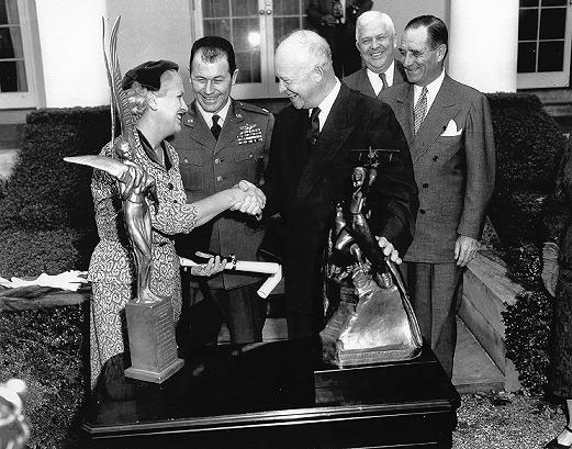 Jackie Cochran and Chuck Yeager being presented with the Harmon International Trophies by President Dwight D. Eisenhower, circa 1953-1961