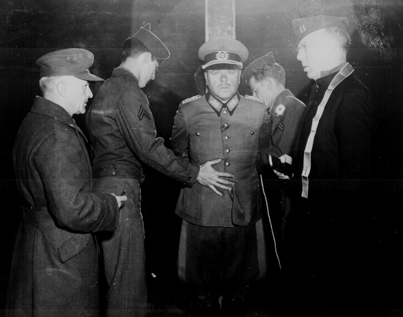 Dostler tied to a stake in preparation of his execution by a firing squad, Aversa, Italy, 1 Dec 1945