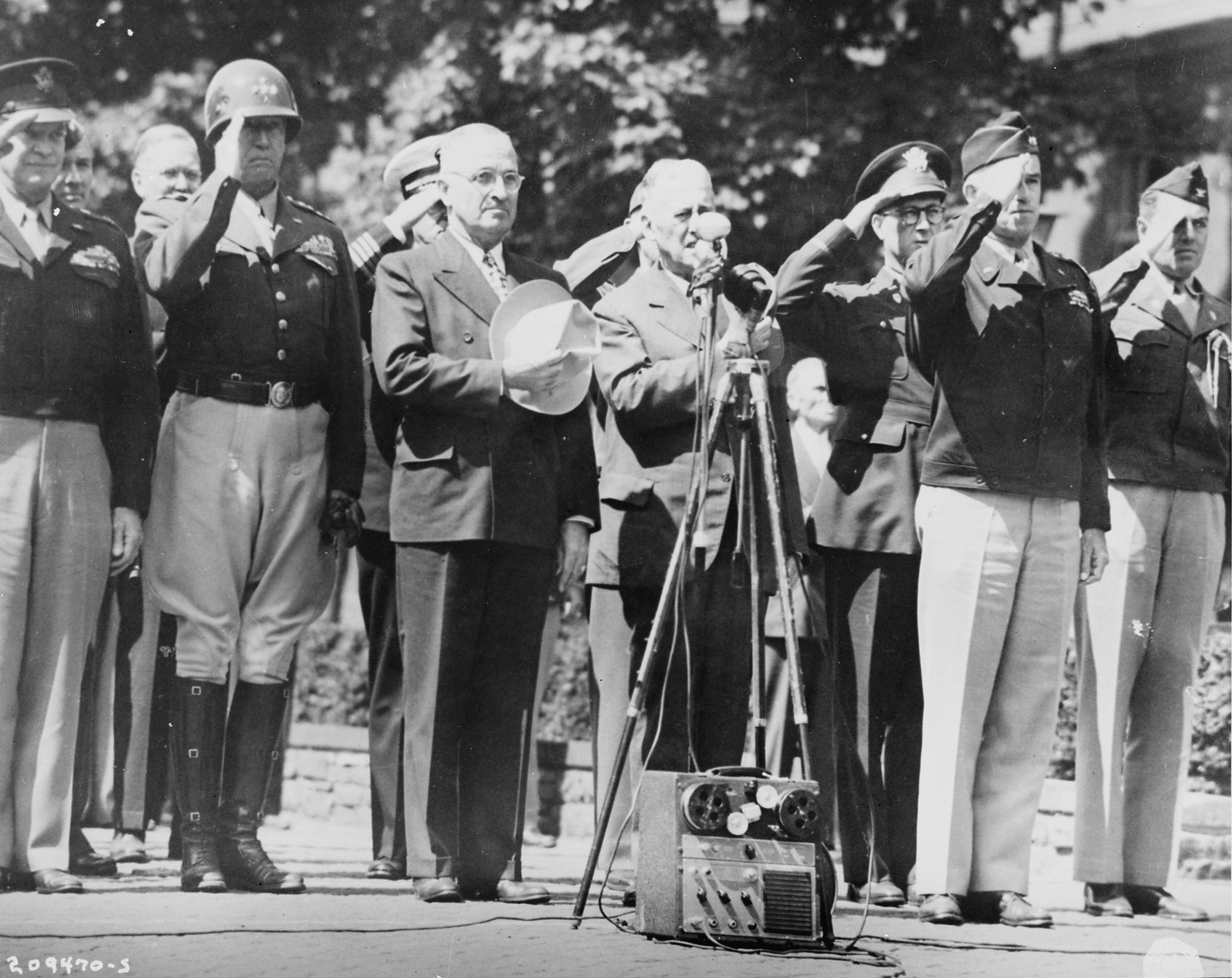 Dwight Eisenhower, George Patton, Harry Truman, Henry Stimson, Omar Bradley, and others during the raising of a US flag over Berlin, Germany, 20 Jul 1945