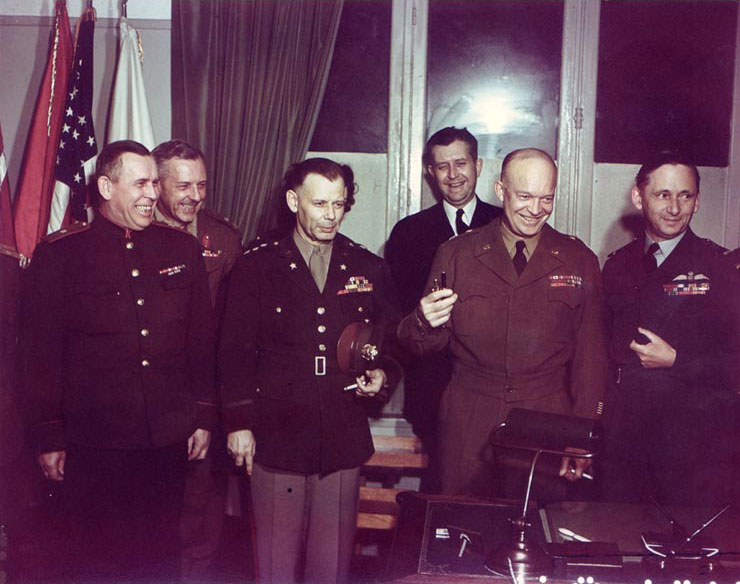 Generals Susloparov, Morgan, Smith, Eisenhower, Air Chief Marshal Tedder after signing of German surrender documents, Rheims, France, 7 May 1945, photo 2 of 3; note Eisenhower holding pens used