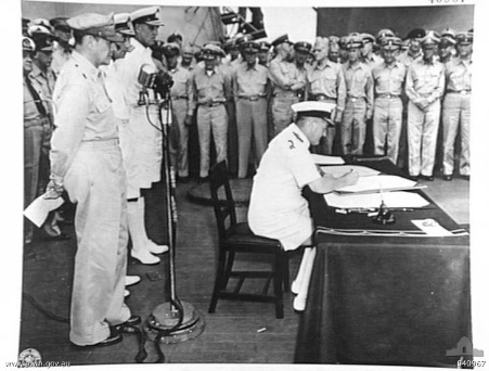 Admiral Sir Bruce Fraser signing the surrender instrument on behalf of the United Kingdom aboard USS Missouri, Tokyo Bay, Japan, 2 Sep 1945, photo 2 of 3