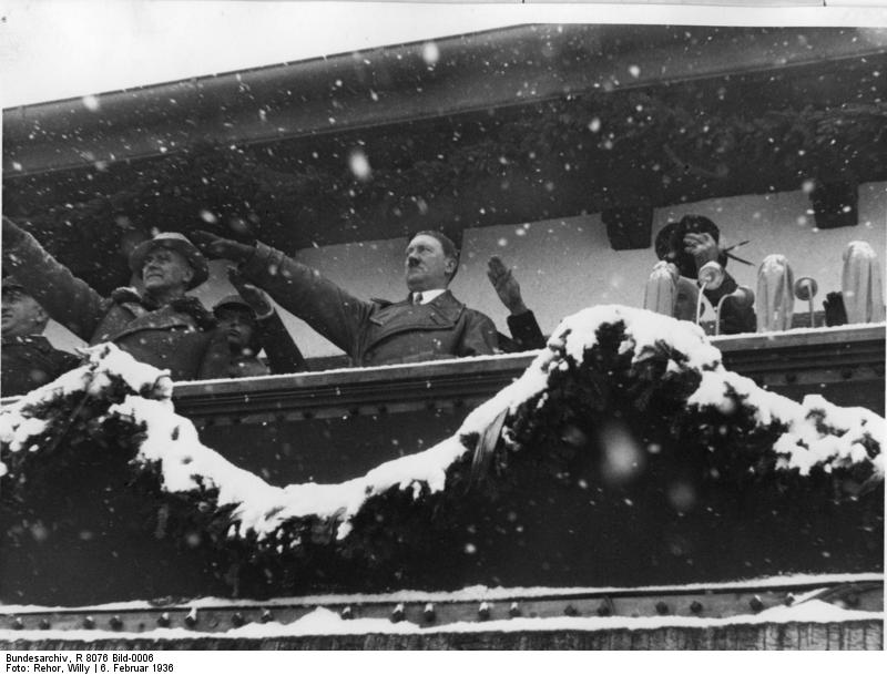 Chancellor Hitler saluting the athletes from balcony of the Olympic House during opening ceremony of the IV Olympic Winter Games, Garmisch-Partenkirchen, Bavaria, Germany, 6 Feb 1936, photo 1 of 4