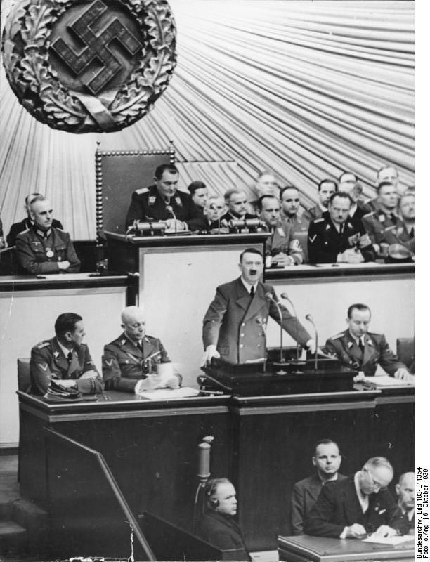 Adolf Hitler giving a speech to the Reichstag, Kroll Opera House, Berlin, Germany, 6 Oct 1939; also present: Göring, Heß, Ribbentrop, Raeder, Frick, Goebbels, Neurath, Frank, Lammers, Seyß-Inquart, Keitel