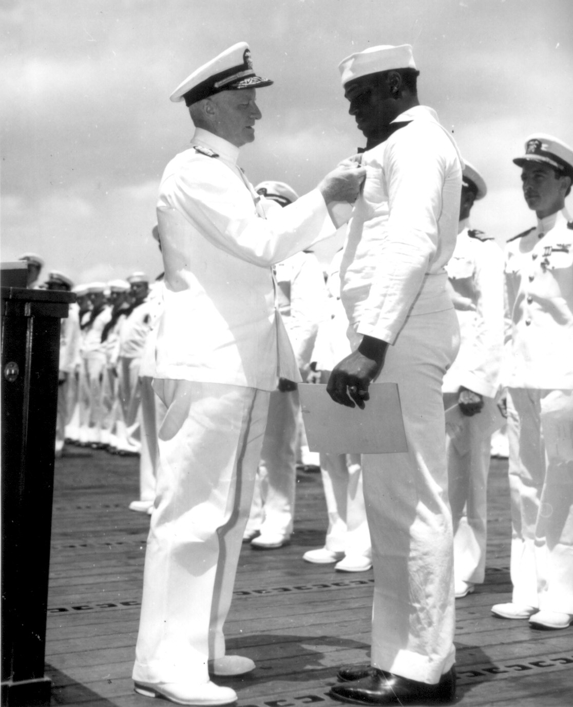 Doris Miller receiving the Navy Cross award from Admiral Chester Nimitz, onboard carrier Enterprise, Pearl Harbor, US Territory of Hawaii, 27 May 1942; photo 2 of 2