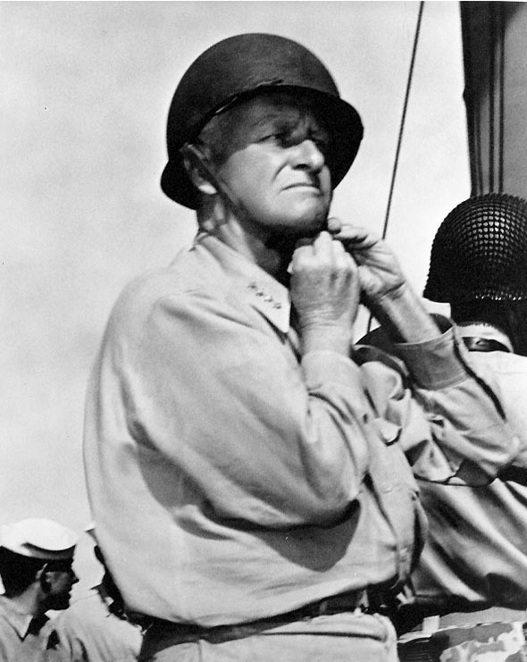 US Admiral Chester Nimitz Chester putting on a steel helmet aboard an American warship, circa 1944