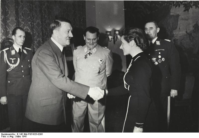 Adolf Hitler awarding Hanna Reitsch the Iron Cross 2nd Class medal, Mar 1941; Luftwaffe adjutant Nicolaus von Below, Hermann Göring, and Air Ministry LtGen Karl Bodenschatz in background