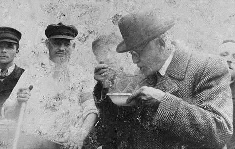 Chaim Rumkowski tasting soup made at a public kitchen in the Lódz ghetto, Poland, 1939-1944