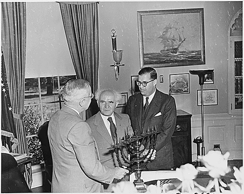 Israeli Prime Minister David Ben-Gurion presenting US President Harry Truman with a Menorah, White House, Washington DC, United States, 8 May 1951; Israeli Ambassador to US Abba Eban also present