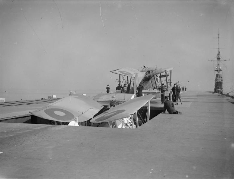 Swordfish aircraft of No. 824 Squadron Fleet Air Arm going down the lift aboard HMS Activity, date unknown