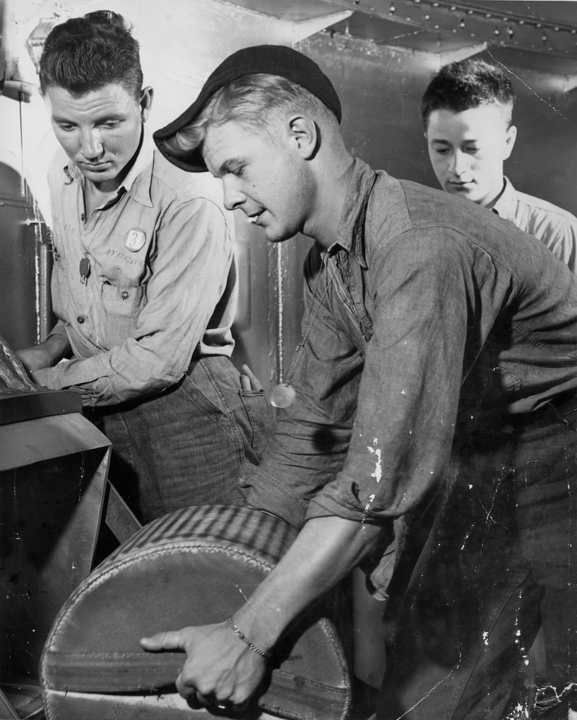 Sailors handling gun powder aboard USS Alabama, off Japan, 1945