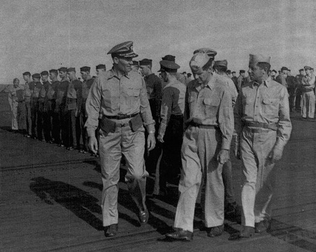 Captain George C. Montgomery inspecting USS Anzio, 16 Dec 1944, photo 1 of 2