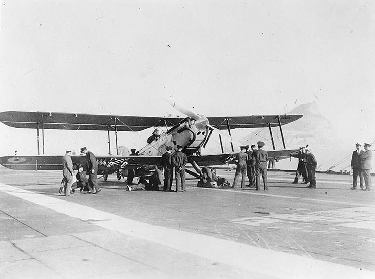 Fairey III-F aircraft on Furious' flight deck, circa late 1920s or early 1930s; note Gibraltar in background