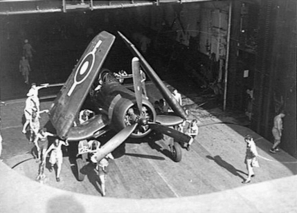 Corsair fighter in an elevator aboard HMS Glory, off Rabaul, New Britain, 6 Sep 1945, photo 1 of 2