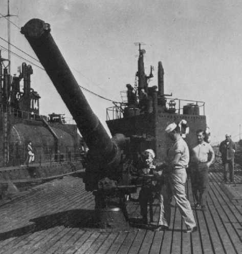US Navy personnel inspecting a deck gun aboard Japanese submarine I-400, circa late 1945 or early 1946