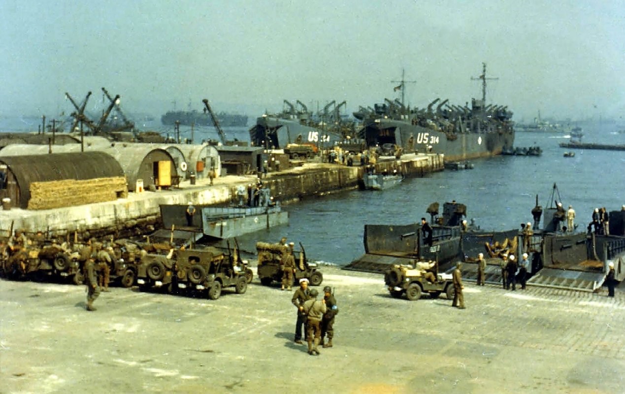 American Jeeps being loaded onto LCTs while larger trucks and DUKWs were being loaded onto LSTs, England, United Kingdom, Jun 1944