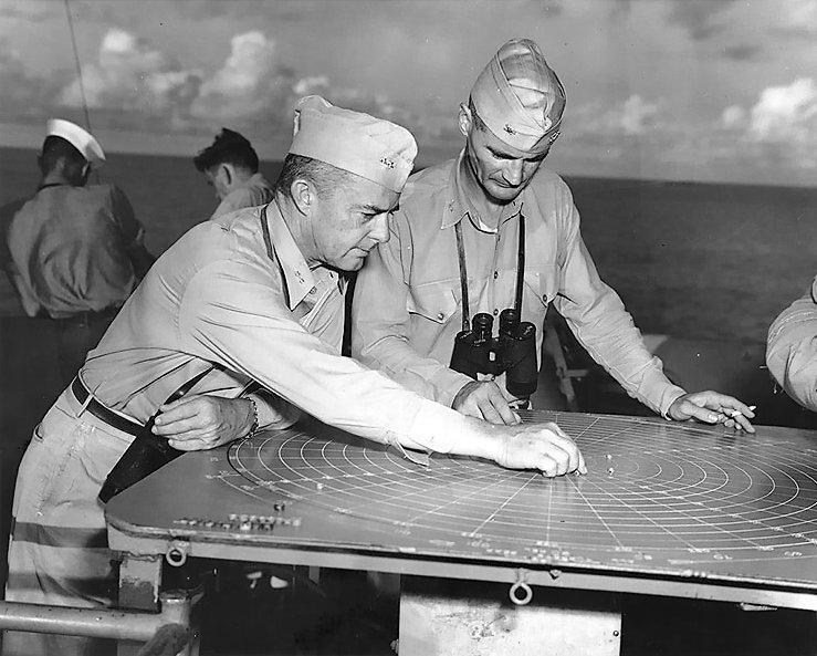 Rear Admiral Aaron Merrill working with Captain W. D. Brown aboard USS Montpelier, Solomon Islands area, 23 Dec 1943