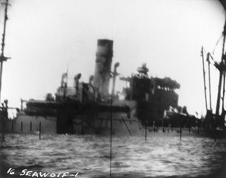A Japanese ship sinking, seen from USS Seawolf's periscope, as the result of torpedo attack, fall 1942; ship was possibly Gifu Maru, sunk in Davao Gulf, Philippine Islands, 2 Nov 1942, photo 1 of 2