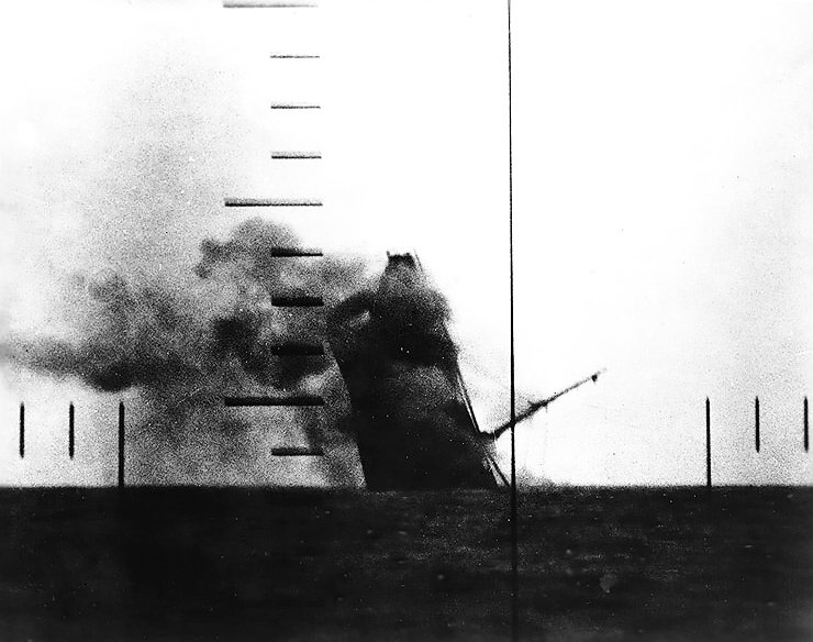 Japanese cargo ship Nittsu Maru sinking in the Yellow Sea, off China, after being torpedoed by American submarine USS Wahoo, 23 Mar 1943; photo taken from Wahoo's periscope