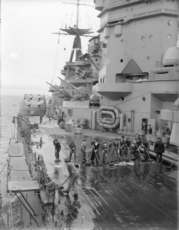 Sailors washing down the decks aboard HMS Rodney, Aug 1940