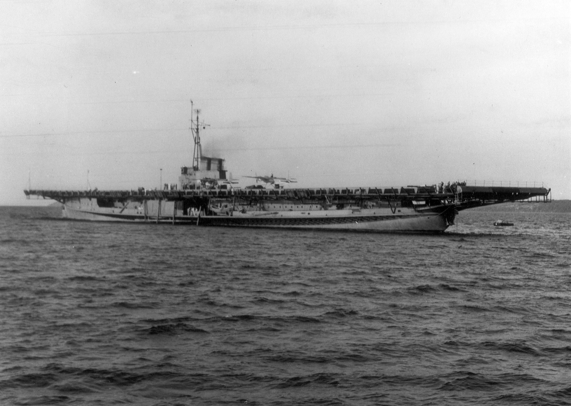 USS Sable at anchor in West Grand Traverse Bay, off Traverse City, Michigan, United States, 10 Aug 1943; note two TDN-1 assault drone on the flight deck