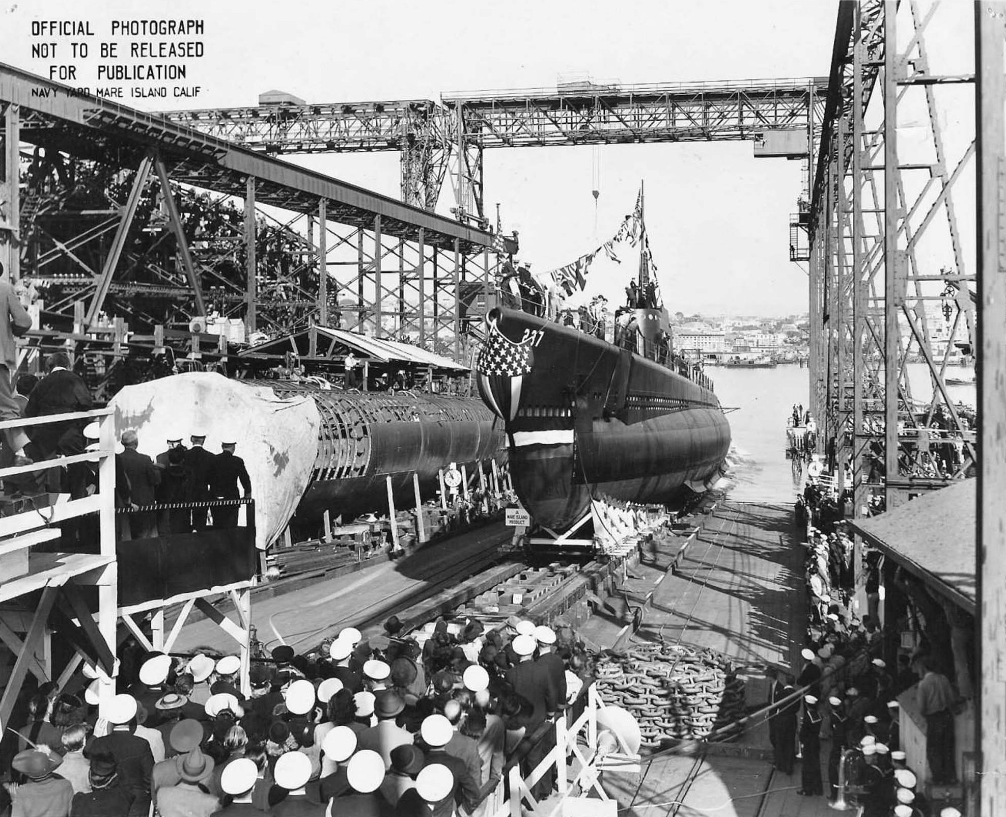 Launching of Trigger, Mare Island Navy Yard, Vallejo, California, United States, 22 Oct 1941; note submarine Sunfish and submarine tender Sperry in background