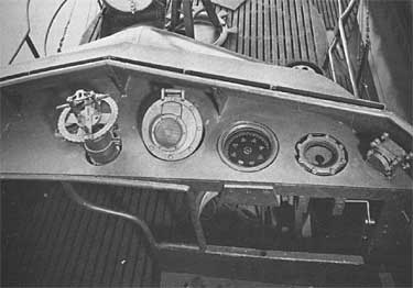 Instrument panel at the open bridge of USS Tang, date unknown; left to right: target bearing transmitter, speaker-microphone, gyrocompass repeater, rudder angle indicator, and diving alarm