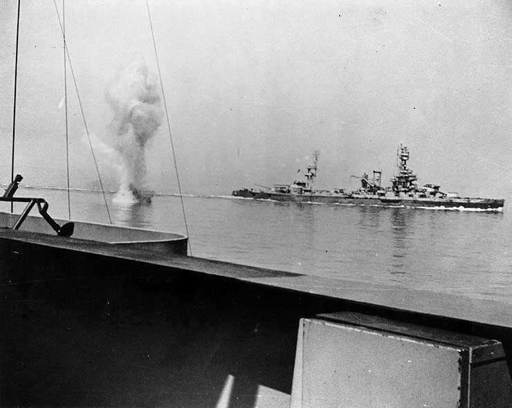A heavy German coast artillery shell fell between Texas (background) and Arkansas (foreground) off Cherbourg, France, 25 Jun 1944