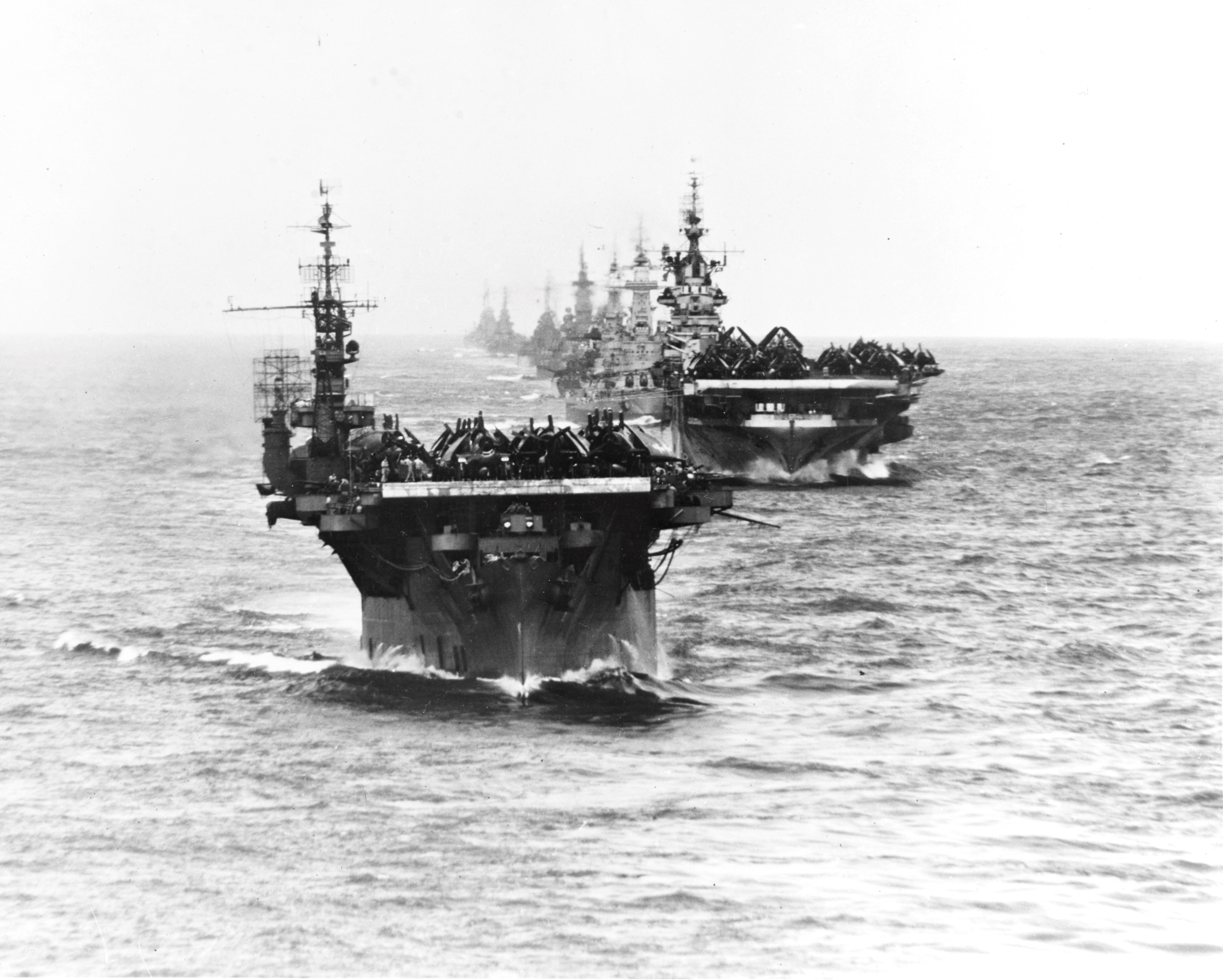 US Navy Task Group 38.3 entering Ulithi anchorage in a column following strikes in Philippine Islands, 24 Dec 1944, photo 2 of 7