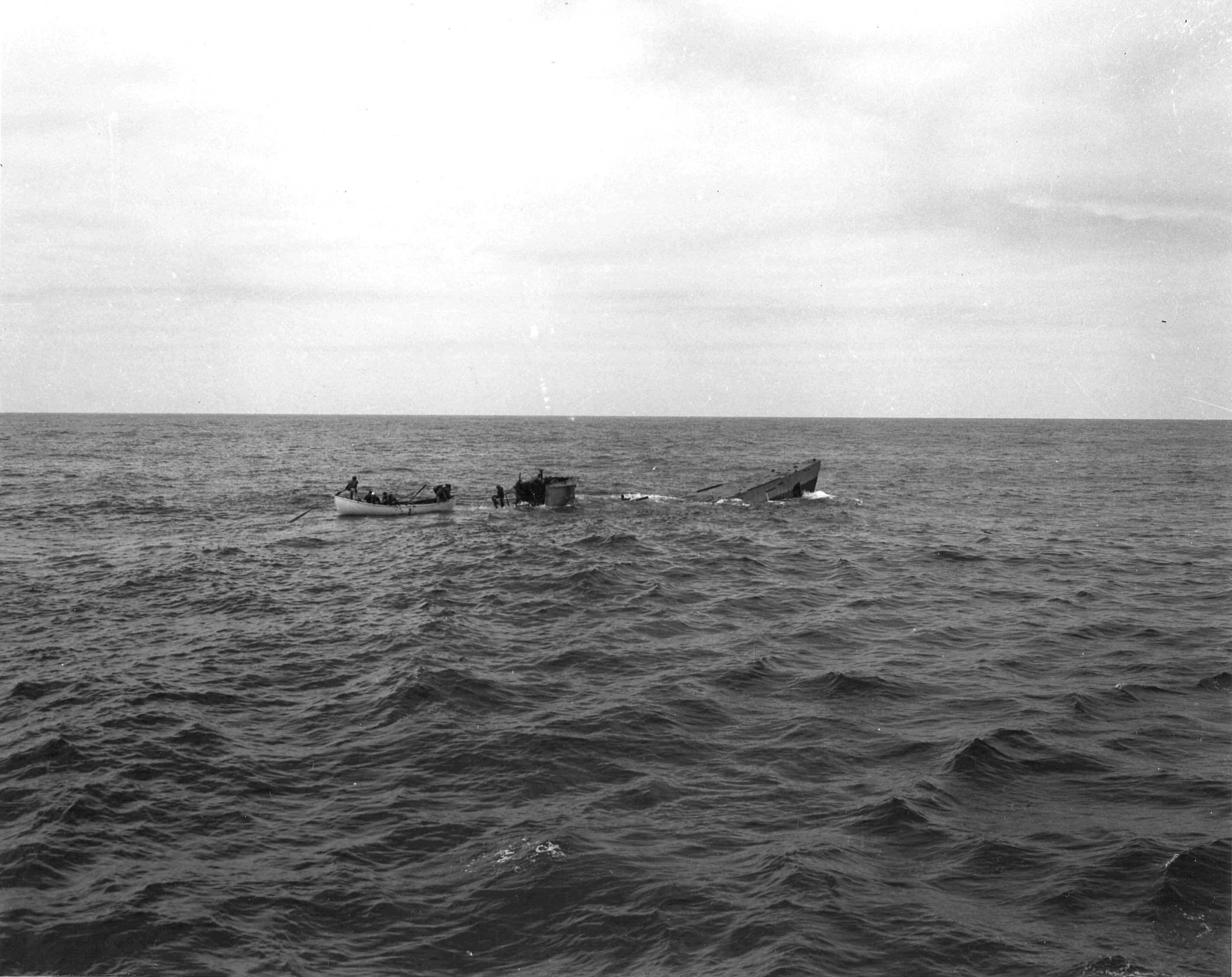 Boarding party from Coast Guard cutter Spencer approaching the U-175 after the sub was forced to the surface by depth charges, North Atlantic, 500 nautical miles WSW of Ireland, 17 Apr 1943. Minutes later, U-175 sank.