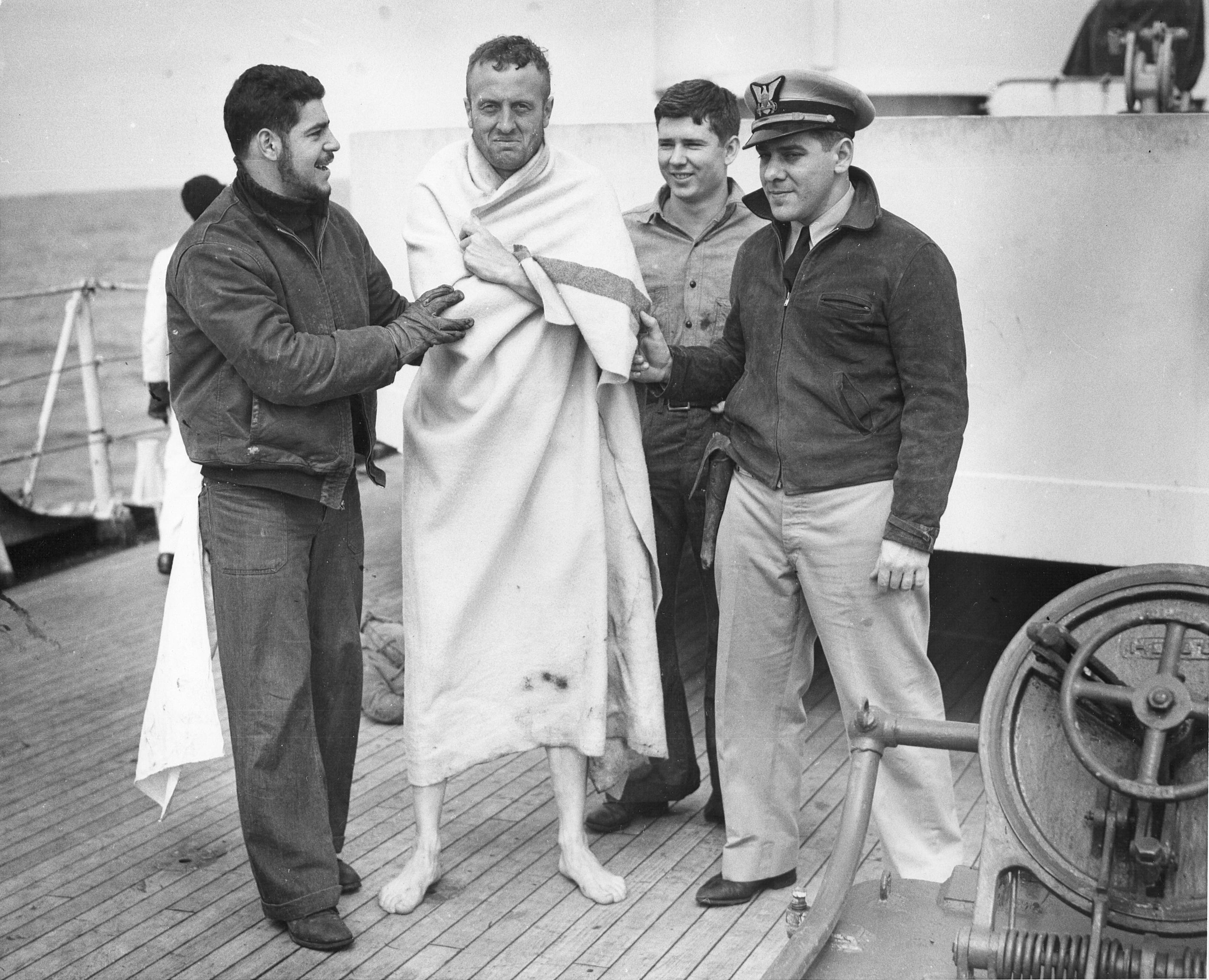Crew of USS Spencer cared for rescued U-175 sailors, North Atlantic, 500 nautical miles WSW of Ireland, 17 Apr 1943, photo 1 of 2