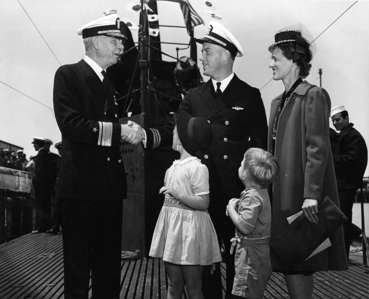 Rear Admiral W. L. Friedell greeting Lieutenant Commander Richard O'Kane aboard USS Wahoo at Mare Island Navy Yard, Vallejo, California, United States, 29 May 1943; note O'Kane's family