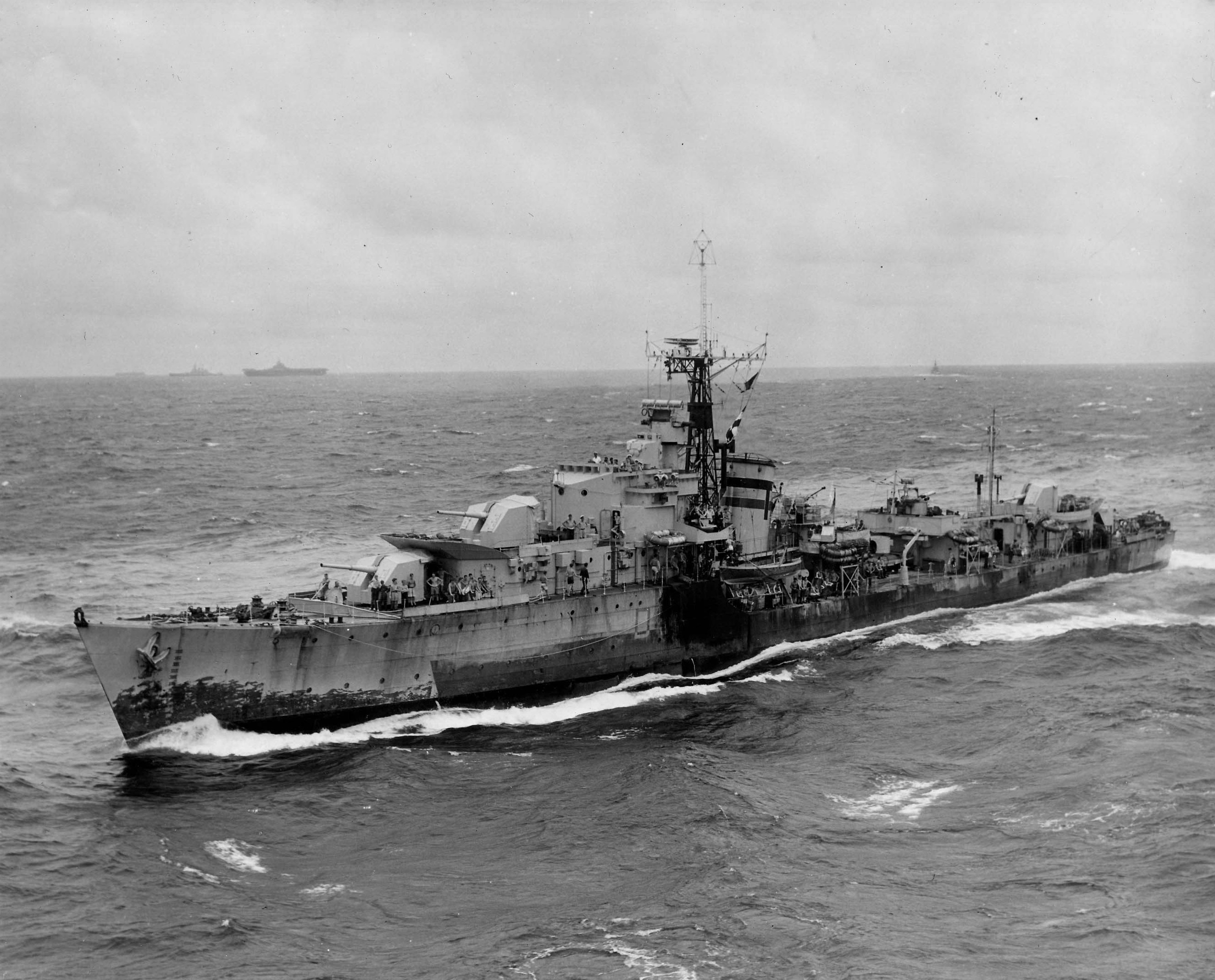 British Royal Navy T-class destroyer, probably HMS Terpsichore (D48), sailing alongside USS Wasp (Essex-class) of US Navy Task Group 38.3 off Japan Aug 1945; note USS Randolph in background