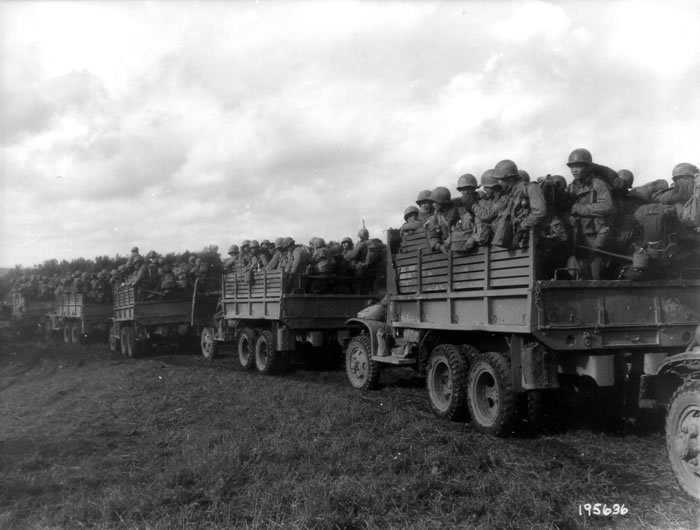 Convoy of CCKW 2 1/2-ton troop transports, date unknown