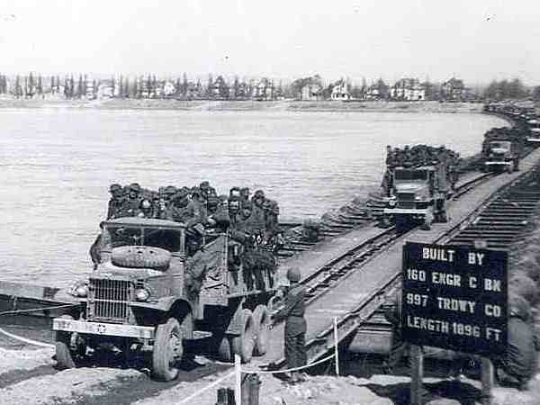 US Army CCKW 2 1/2-ton cargo trucks crossing the Rhine River near Mainz, Germany, Mar or Apr 1945; the passengers were possibly German POWs