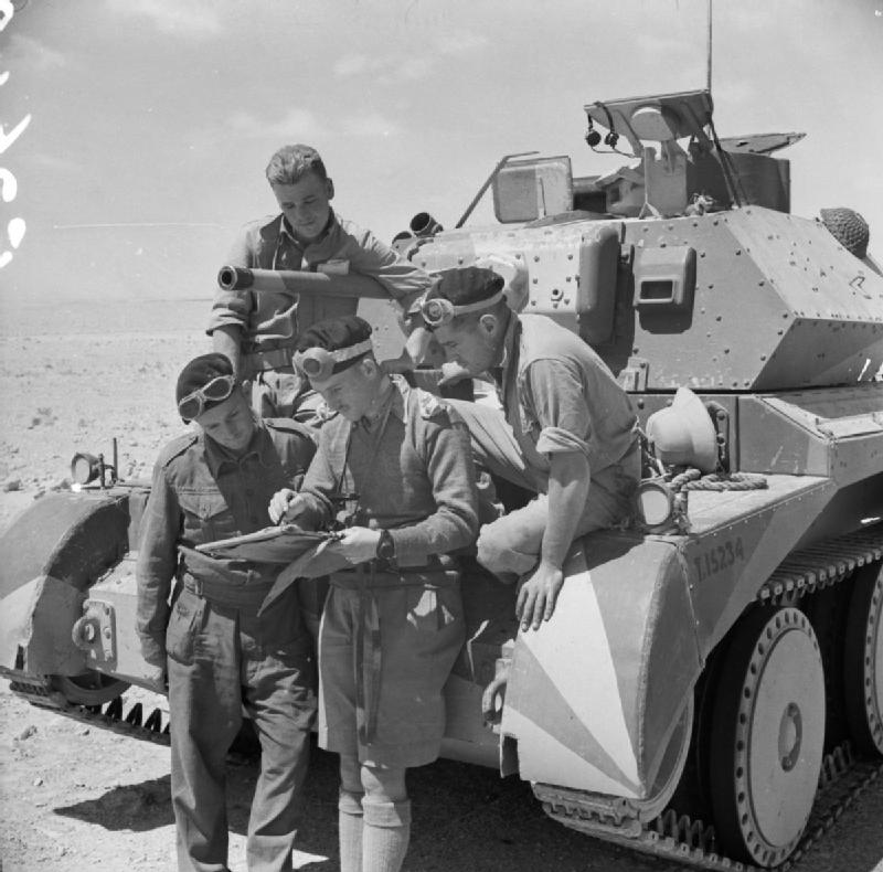 The crew of a British Cruiser Mk IV tank studying a map in the Western Desert, Egypt, 30 Apr 1941