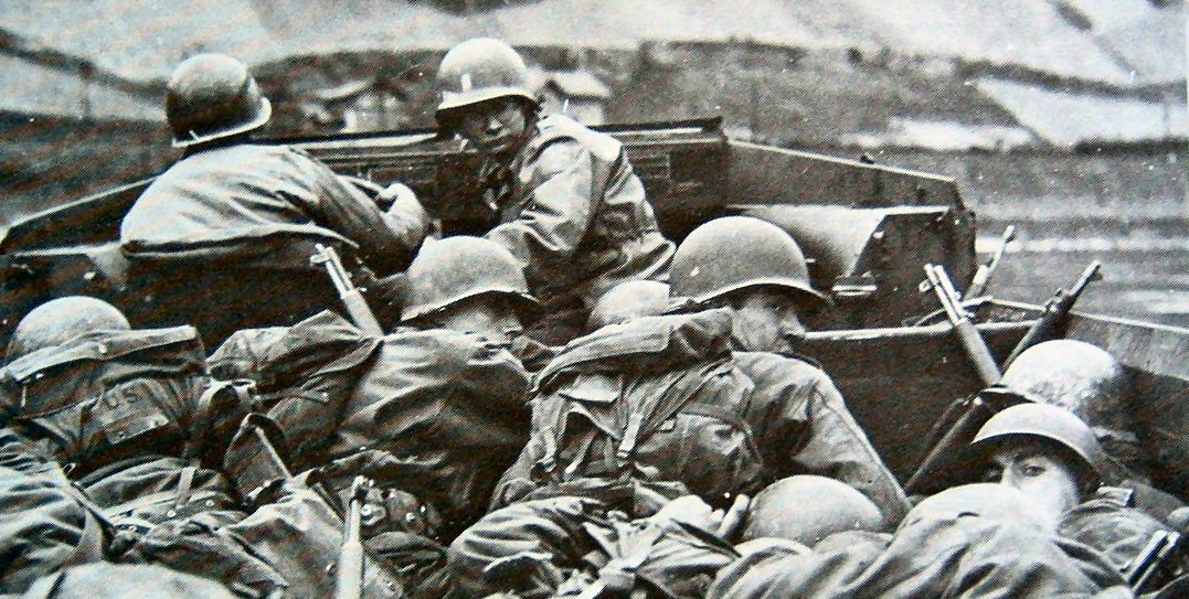 US Army troops taking cover in a DUKW as they approached a hostile beach, date unknown; note tips of M1 Garand rifles