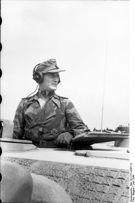 A German Jagdpanther tank destroyer crewman atop the vehicle during the Allied invasion of France, Jun 1944 