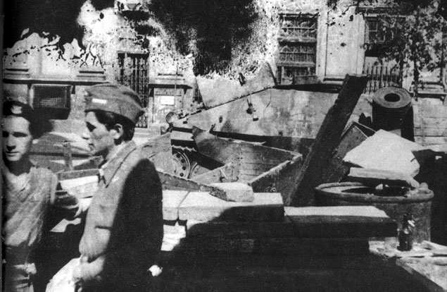 Polish barricade at Napoleon Square, Warsaw, Poland, 3 Aug 1944, photo 4 of 4; note captured Jagdpanzer 38(t) tank destroyer as part of barricade