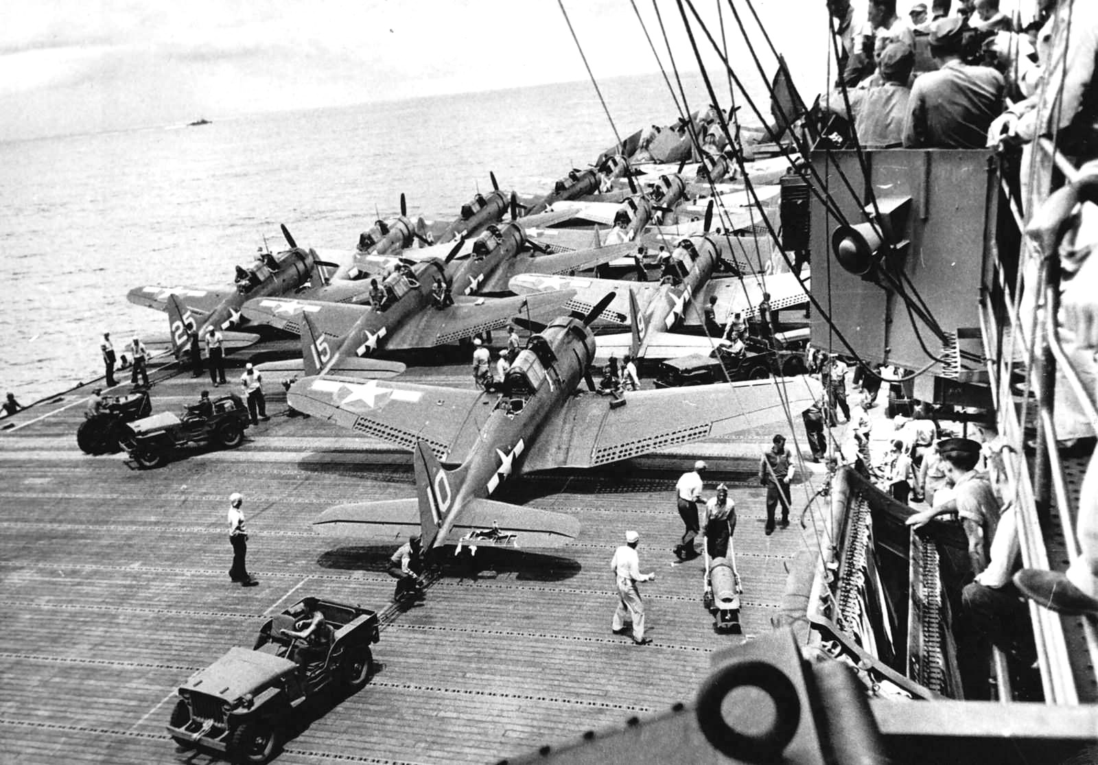 Jeep vehicles and SBD Dauntless aircraft aboard an aircraft carrier in the Solomon Islands area, 5 Nov 1943