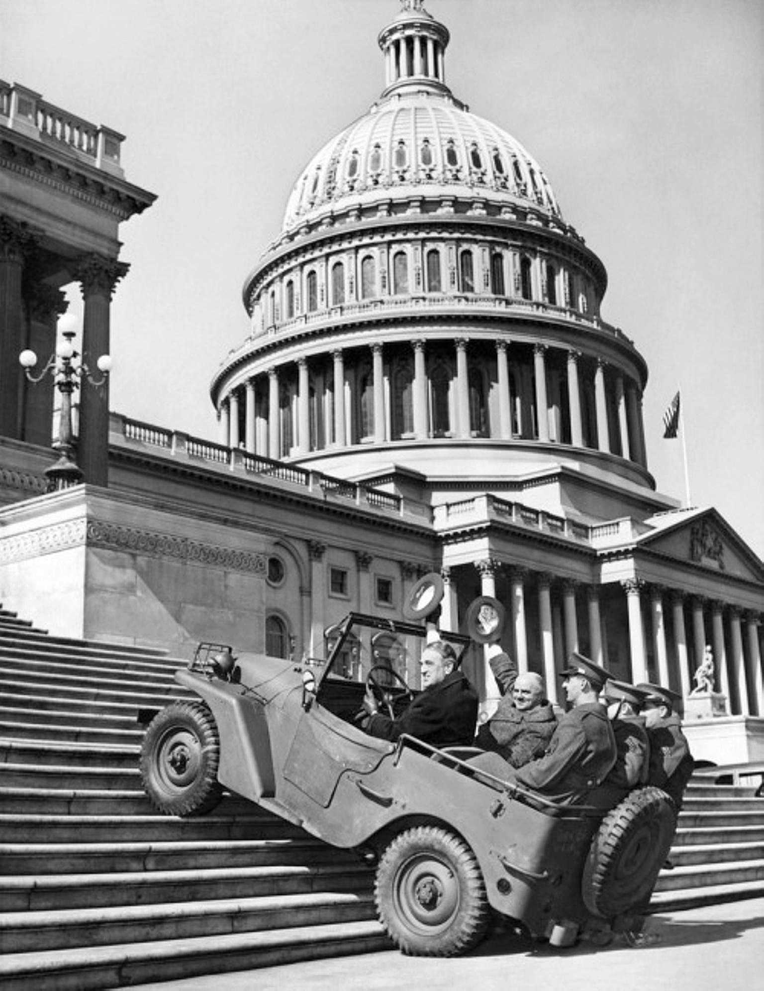 US Senators William Meade (NY) and Elbert Thomas (UT) riding a Willys Quad as it climbed steps in front of the US Congress building, Washington, DC, United States, seen in 20 Feb 1941 issue of the Washington Daily News