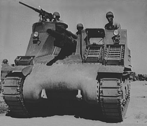 M7 self-propelled artillery vehicle being tested for desert warfare near Iron Mountain, California, United States, circa 1940; the men were Corporal Downing (left, manning machine gun), Corporal L. Roberts (center, manning howitzer), and Lieutenant M. Hutchison (right); photo 2 of 2